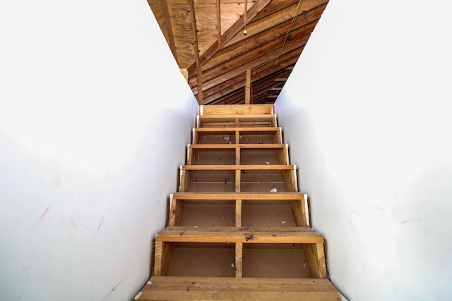 staircase with lofted ceiling