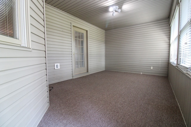 unfurnished sunroom featuring wooden ceiling