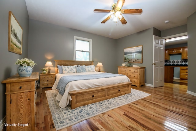 bedroom featuring ceiling fan and hardwood / wood-style flooring