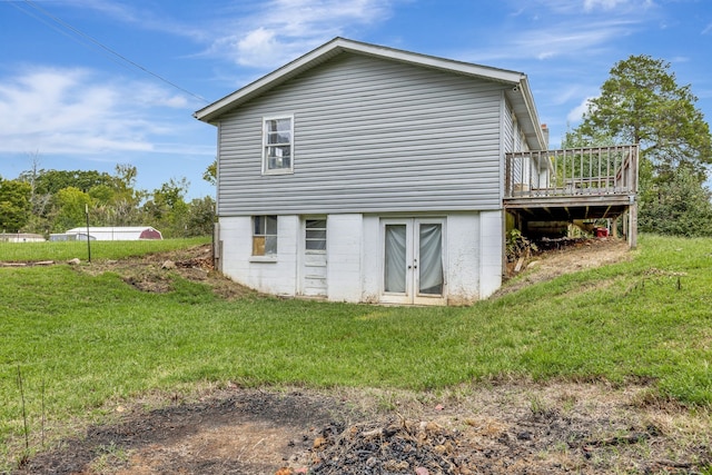 view of home's exterior with a wooden deck and a yard