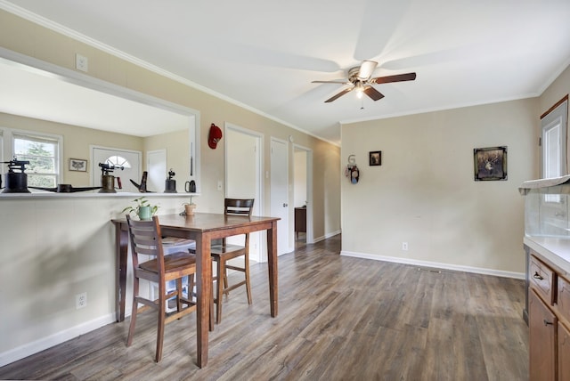 dining area with hardwood / wood-style flooring, ceiling fan, and crown molding