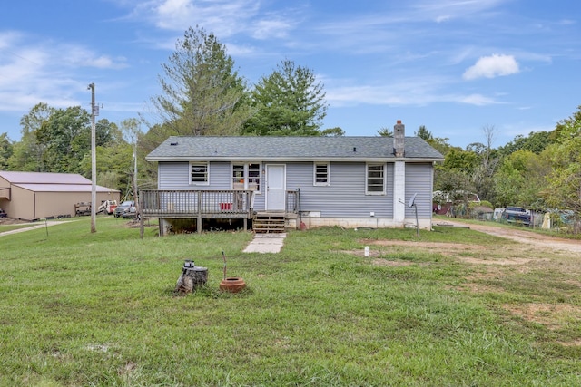 view of front of property featuring a front yard and a wooden deck