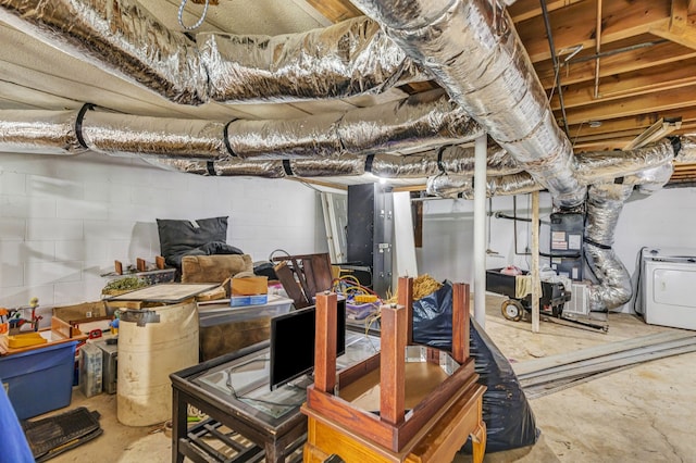 basement featuring heating unit and washer / dryer