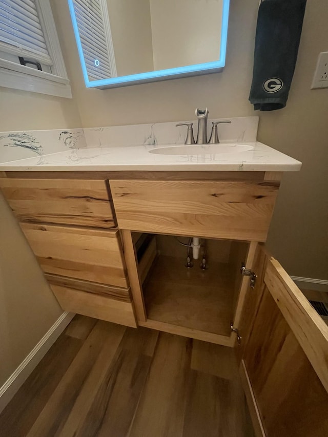 bathroom with vanity and hardwood / wood-style flooring