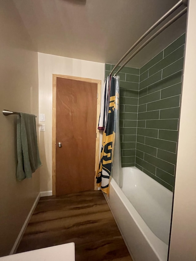 bathroom featuring shower / bath combo with shower curtain and hardwood / wood-style flooring