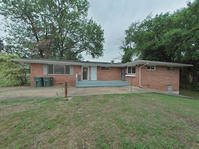 single story home with a front yard and a patio area