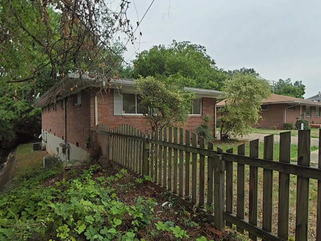 view of side of home with central air condition unit