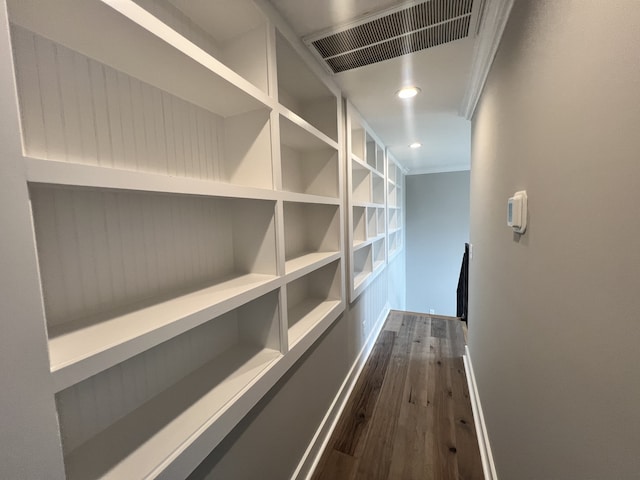 corridor featuring crown molding and dark hardwood / wood-style floors