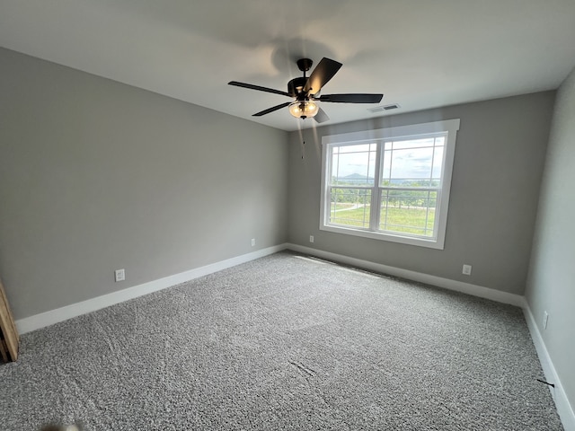 empty room with carpet and ceiling fan