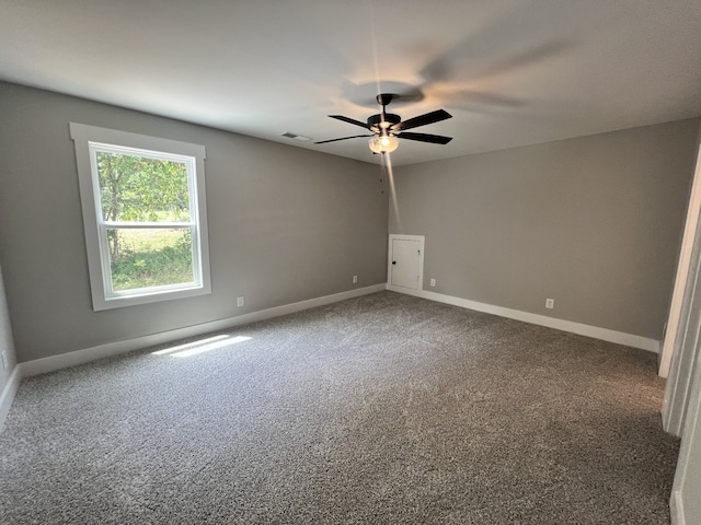 carpeted spare room with ceiling fan