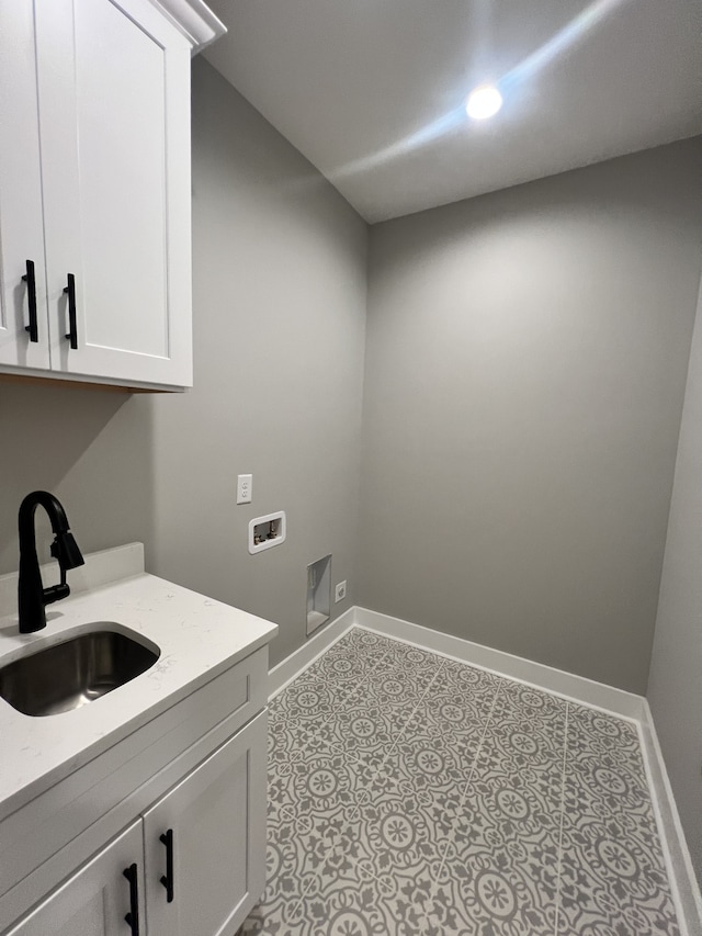 laundry room featuring hookup for a washing machine, sink, and cabinets