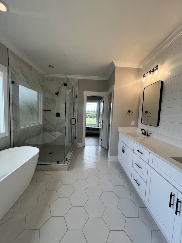 bathroom with crown molding, independent shower and bath, vanity, and tile patterned floors