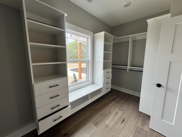 spacious closet with light hardwood / wood-style flooring