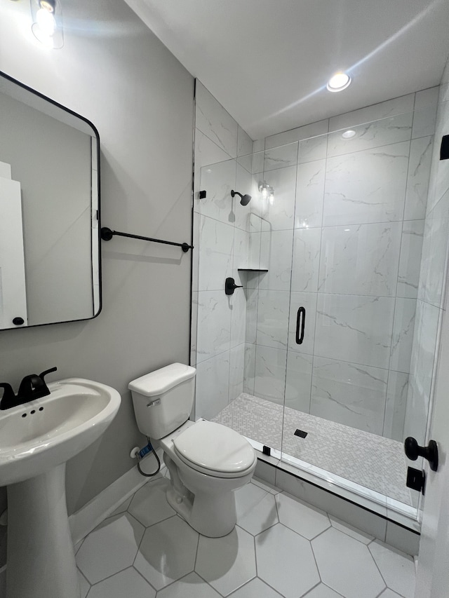 bathroom with walk in shower, toilet, and tile patterned floors