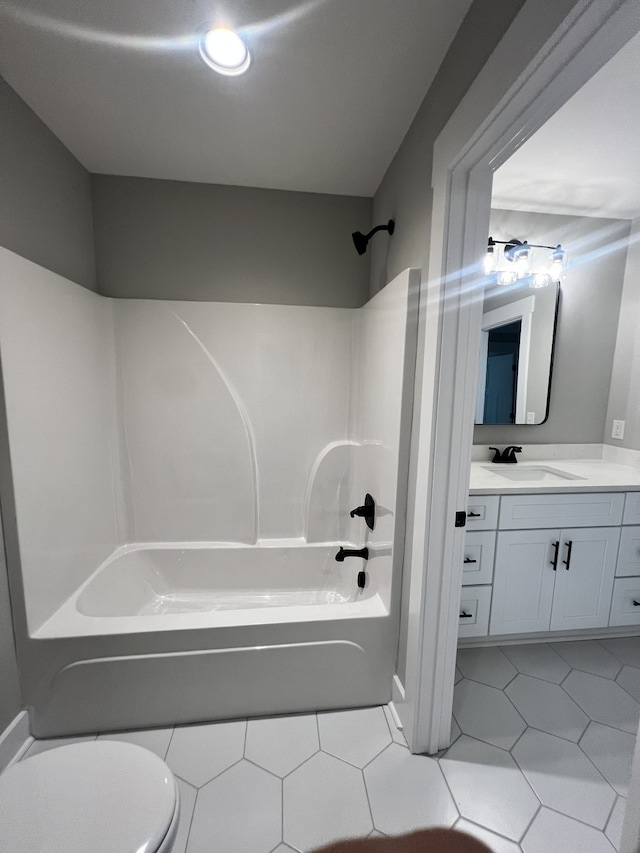 full bathroom featuring vanity, tile patterned flooring, toilet, and shower / washtub combination