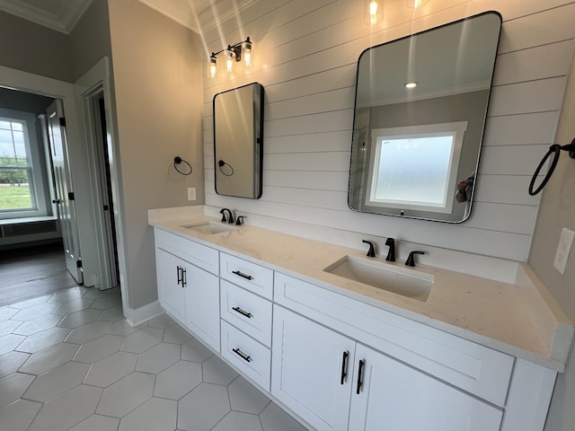 bathroom with ornamental molding, tile patterned floors, and vanity