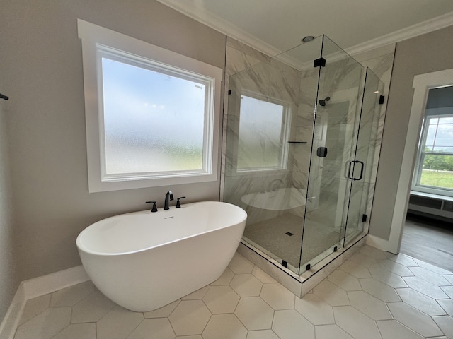 bathroom featuring ornamental molding, shower with separate bathtub, plenty of natural light, and tile patterned floors