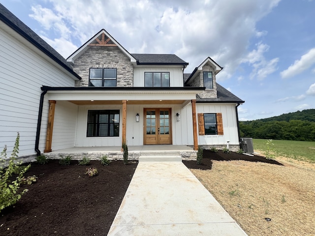 modern farmhouse featuring a porch and central AC