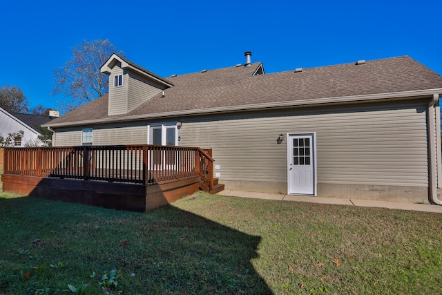 rear view of house with a yard and a deck