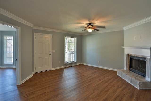 unfurnished living room featuring ornamental molding, dark hardwood / wood-style flooring, ceiling fan, and a tile fireplace