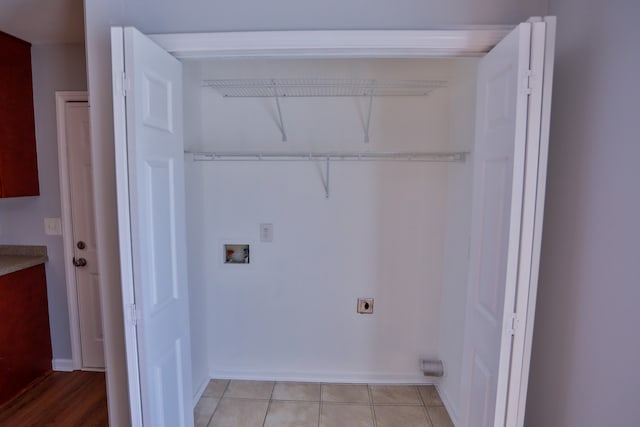 clothes washing area with light tile patterned floors, hookup for a washing machine, and hookup for an electric dryer