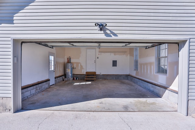 garage with electric panel and water heater