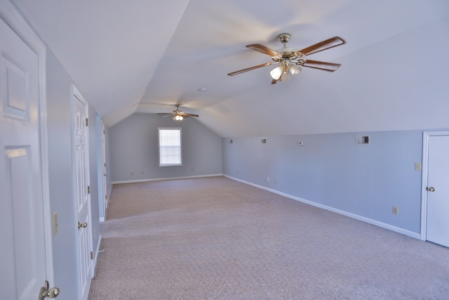 additional living space with light colored carpet, lofted ceiling, and ceiling fan