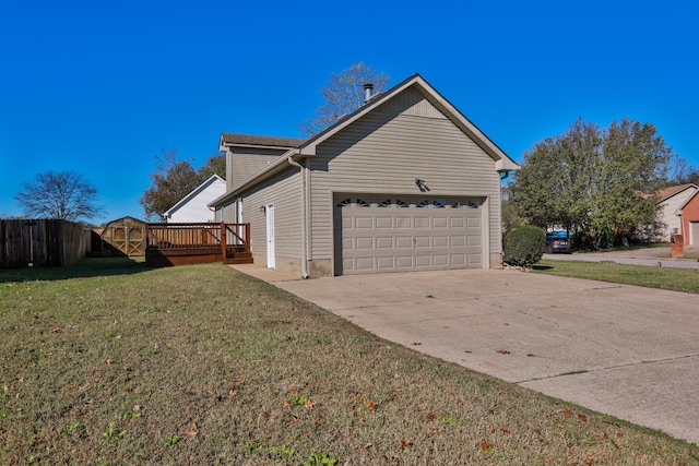 view of side of property featuring a garage, a yard, and a deck