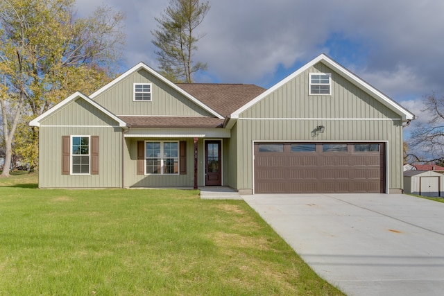 view of front of property with a front yard and a garage