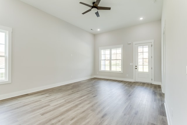 unfurnished room with ceiling fan and light hardwood / wood-style flooring