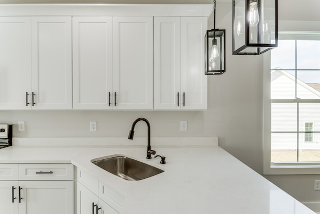 kitchen with white cabinetry and sink