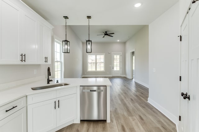 kitchen with stainless steel dishwasher, ceiling fan, sink, light hardwood / wood-style flooring, and white cabinetry