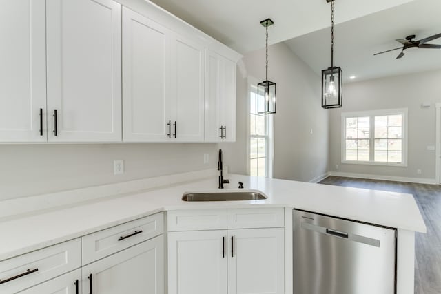 kitchen with stainless steel dishwasher, ceiling fan, sink, wood-type flooring, and white cabinetry