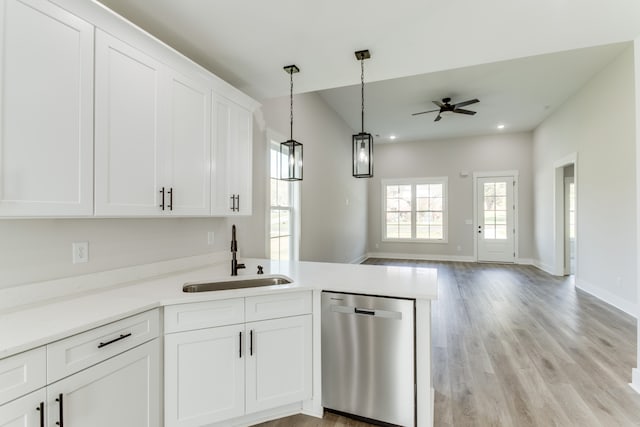 kitchen with stainless steel dishwasher, ceiling fan, white cabinetry, and sink