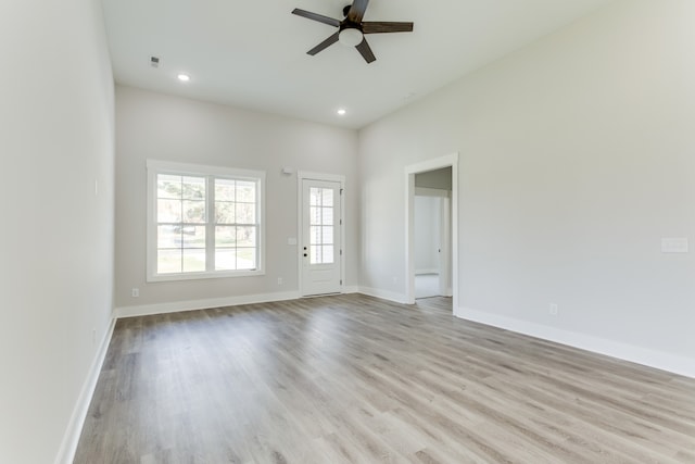 spare room with light wood-type flooring and ceiling fan