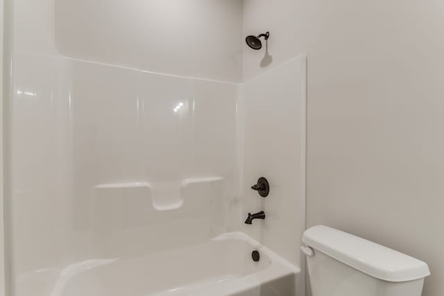 bathroom featuring shower / bathing tub combination and toilet