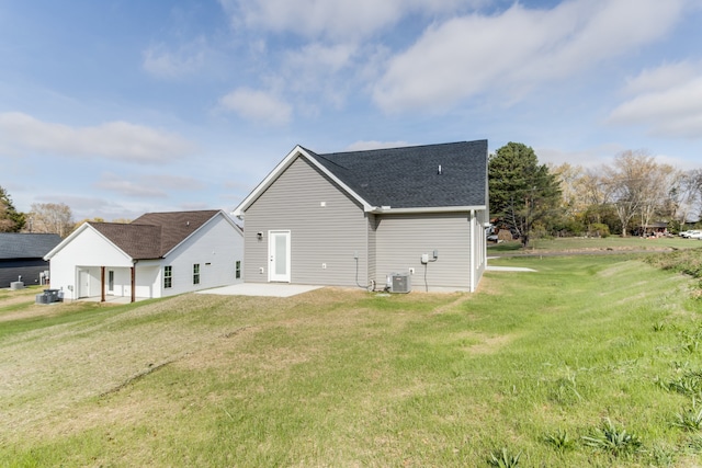 rear view of property featuring a yard, a patio, and cooling unit