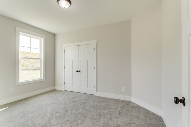 unfurnished bedroom with carpet and a closet