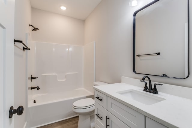 full bathroom with hardwood / wood-style flooring, vanity, toilet, and bathtub / shower combination