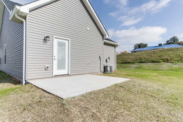 back of house with a patio area and a yard