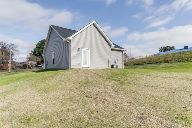 back of property with a yard and central AC unit