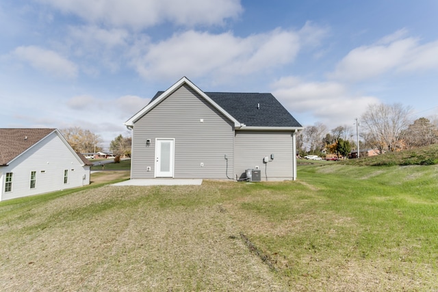 rear view of property with a patio area, a yard, and central air condition unit