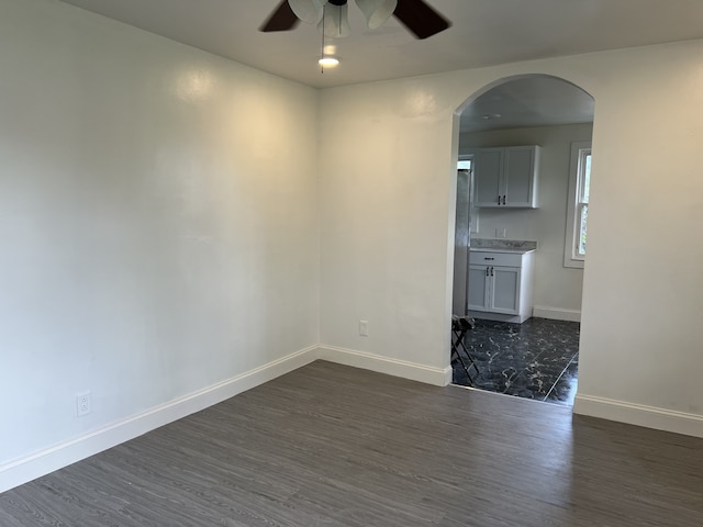 unfurnished room featuring ceiling fan and dark hardwood / wood-style floors