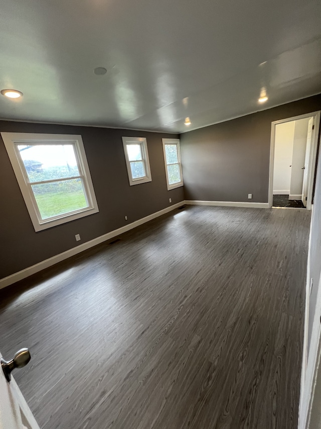 unfurnished room featuring dark wood-type flooring