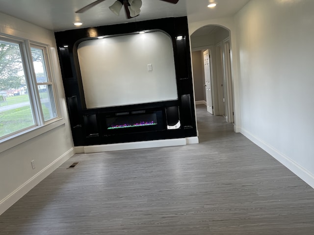 home theater room with ceiling fan and hardwood / wood-style flooring