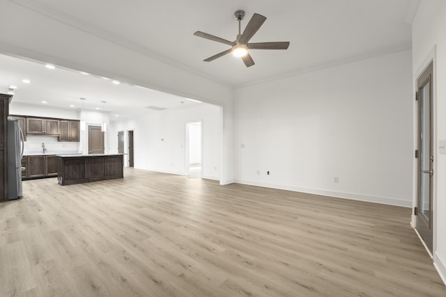 unfurnished living room with crown molding, light hardwood / wood-style floors, and ceiling fan