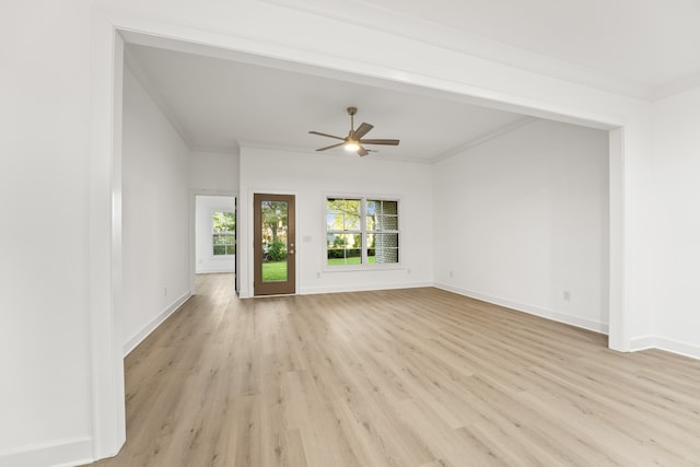 empty room featuring light hardwood / wood-style floors, ornamental molding, and ceiling fan