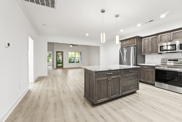 kitchen with dark brown cabinets, light stone counters, light hardwood / wood-style flooring, appliances with stainless steel finishes, and ceiling fan