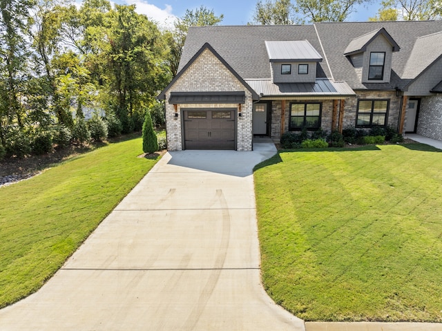 view of front of property featuring a front lawn and a garage