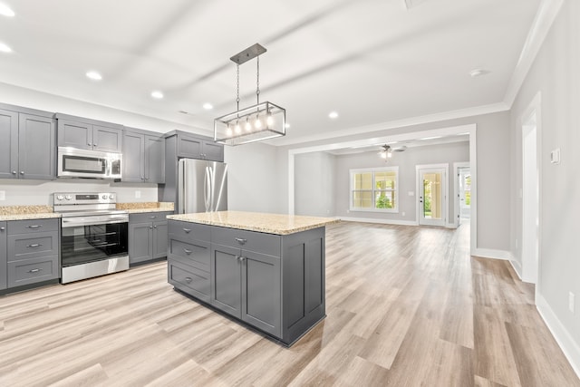 kitchen with gray cabinets, a center island, appliances with stainless steel finishes, decorative light fixtures, and ornamental molding